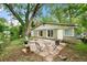 Green backyard with stone patio and mature trees at 2364 Woodside Way, Atlanta, GA 30341