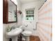 Clean bathroom featuring a white sink, toilet, and shower with a striped curtain at 2364 Woodside Way, Atlanta, GA 30341