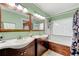 Bathroom with double sink vanity, tub, tile details, and wood accents at 2364 Woodside Way, Atlanta, GA 30341
