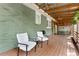 Side yard featuring green grass, flowerbeds, and a driveway leading up to an attached garage at 2364 Woodside Way, Atlanta, GA 30341