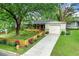 Charming single-story home with a covered porch, an attached garage, and a landscaped front yard at 2364 Woodside Way, Atlanta, GA 30341