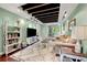 Inviting living room boasts exposed wood beams, a large rug, and lots of natural light at 2364 Woodside Way, Atlanta, GA 30341