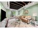 Open living room with exposed beam ceiling, hardwood floors, and bright-green walls at 2364 Woodside Way, Atlanta, GA 30341
