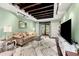 Cozy living room featuring exposed-beam ceilings, a sofa, a TV, and French doors to the backyard at 2364 Woodside Way, Atlanta, GA 30341