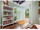 Bright living room features hardwood floors, open shelving, and a doorway to the backyard at 2364 Woodside Way, Atlanta, GA 30341