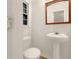 Powder room featuring pedestal sink, toilet, and a window at 4261 E Conley Rd, Conley, GA 30288