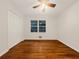 Bedroom featuring wood floors, ceiling fan with lighting, and a double-door closet at 4261 E Conley Rd, Conley, GA 30288
