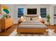 Stylish, virtually staged bedroom with wood floors, soft lighting, and a cozy, comfortable bed at 4261 E Conley Rd, Conley, GA 30288