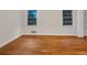 Bright bedroom features hardwood floors, white walls, and two large windows for natural light at 4261 E Conley Rd, Conley, GA 30288