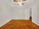 Spacious bedroom features a ceiling fan with lighting, hardwood flooring, and an open doorway at 4261 E Conley Rd, Conley, GA 30288