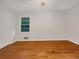 Bedroom features neutral walls, hardwood flooring, and a window overlooking the backyard at 4261 E Conley Rd, Conley, GA 30288
