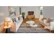 Bright, virtually staged living room features modern furniture, striped rug, and contemporary decor at 4261 E Conley Rd, Conley, GA 30288