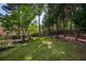 A beautifully landscaped backyard with a lush lawn and mature trees, perfect for outdoor enjoyment at 818 Forest Path Ln, Alpharetta, GA 30022