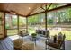 Covered porch overlooking lush backyard featuring mature trees and garden at 818 Forest Path Ln, Alpharetta, GA 30022