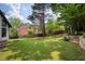 Beautiful backyard with mature trees, stone terracing, and lush landscaping at 818 Forest Path Ln, Alpharetta, GA 30022