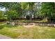 Lush backyard featuring tiered stone landscape and mature trees at 818 Forest Path Ln, Alpharetta, GA 30022