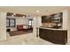 Open layout basement with a kitchen area and a living space with red sofas at 818 Forest Path Ln, Alpharetta, GA 30022
