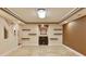 Spacious finished basement area with fireplace, shelving, and recessed lighting at 818 Forest Path Ln, Alpharetta, GA 30022