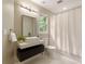 Modern bathroom with floating vanity, contemporary fixtures, and a shower with curtain at 818 Forest Path Ln, Alpharetta, GA 30022