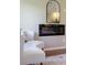 Cozy chair in the bedroom next to a modern electric fireplace with a sleek black frame at 818 Forest Path Ln, Alpharetta, GA 30022
