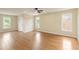 Large bedroom offering wood floors, three windows and a ceiling fan for natural light at 818 Forest Path Ln, Alpharetta, GA 30022
