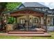 Charming covered patio with an outdoor kitchen and comfortable seating, perfect for entertaining guests at 818 Forest Path Ln, Alpharetta, GA 30022