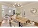 Open dining room with hardwood floors connecting to the living room and kitchen at 818 Forest Path Ln, Alpharetta, GA 30022