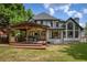 Stunning home exterior with a covered patio, showcasing the well-maintained yard and architectural details at 818 Forest Path Ln, Alpharetta, GA 30022