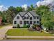 Stunning two-story home with meticulously landscaped front yard, showcasing modern architecture and curb appeal at 818 Forest Path Ln, Alpharetta, GA 30022