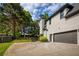 Well-maintained home exterior with a spacious driveway, complemented by manicured landscaping and a fenced yard at 818 Forest Path Ln, Alpharetta, GA 30022