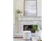 Close up of fireplace with art and greenery at 818 Forest Path Ln, Alpharetta, GA 30022