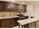 Kitchen area features custom wood cabinets, granite counters, and stainless steel appliances at 818 Forest Path Ln, Alpharetta, GA 30022