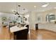 Open-concept kitchen with island seating, stainless appliances, and views into living area at 818 Forest Path Ln, Alpharetta, GA 30022