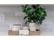 Close up of kitchen backsplash featuring a plant, cups, and a tea towel at 818 Forest Path Ln, Alpharetta, GA 30022