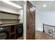 Convenient laundry area with modern washer/dryer, wooden countertops, and barn door at 818 Forest Path Ln, Alpharetta, GA 30022