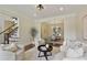 Bright, inviting living room seamlessly flows into dining area with a view of staircase at 818 Forest Path Ln, Alpharetta, GA 30022