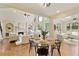 Open-concept living and dining area with vaulted ceilings, large windows, hardwood floors, and a stylish table setting at 818 Forest Path Ln, Alpharetta, GA 30022