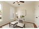 Cozy home office with a window, ceiling fan, white desk, and decor at 818 Forest Path Ln, Alpharetta, GA 30022