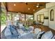 Beautiful covered patio featuring an outdoor kitchen and cozy seating arrangement at 818 Forest Path Ln, Alpharetta, GA 30022