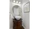 Stylish powder room featuring a vessel sink on a vanity and modern fixtures at 818 Forest Path Ln, Alpharetta, GA 30022