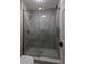 Modern shower featuring sleek glass enclosure, mosaic tiled floor, and premium fixtures at 818 Forest Path Ln, Alpharetta, GA 30022