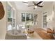 Sunroom with hardwood floors, skylights, and comfortable seating overlooking the backyard at 818 Forest Path Ln, Alpharetta, GA 30022