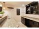 Basement bar featuring a granite countertop and custom wine and glass storage at 818 Forest Path Ln, Alpharetta, GA 30022