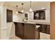 Basement wet bar with granite countertops, custom cabinetry, and glass shelving at 818 Forest Path Ln, Alpharetta, GA 30022