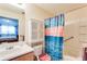 Bright bathroom with colorful shower curtain and white vanity with cabinet at 10202 Fairington Ridge Cir, Lithonia, GA 30038