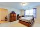 Bright bedroom featuring a large bed, side tables, and natural light at 10202 Fairington Ridge Cir, Lithonia, GA 30038