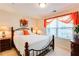 Cozy bedroom features a decorative headboard, bright window, and accent lighting for a comfortable space at 10202 Fairington Ridge Cir, Lithonia, GA 30038