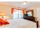 Bright bedroom with a queen bed, window with blinds, and stylish dresser with mirror at 10202 Fairington Ridge Cir, Lithonia, GA 30038