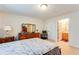 Spacious bedroom featuring a large dresser and ensuite bathroom at 10202 Fairington Ridge Cir, Lithonia, GA 30038
