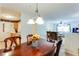 Inviting dining area with chandelier lighting, open to kitchen and living room at 10202 Fairington Ridge Cir, Lithonia, GA 30038